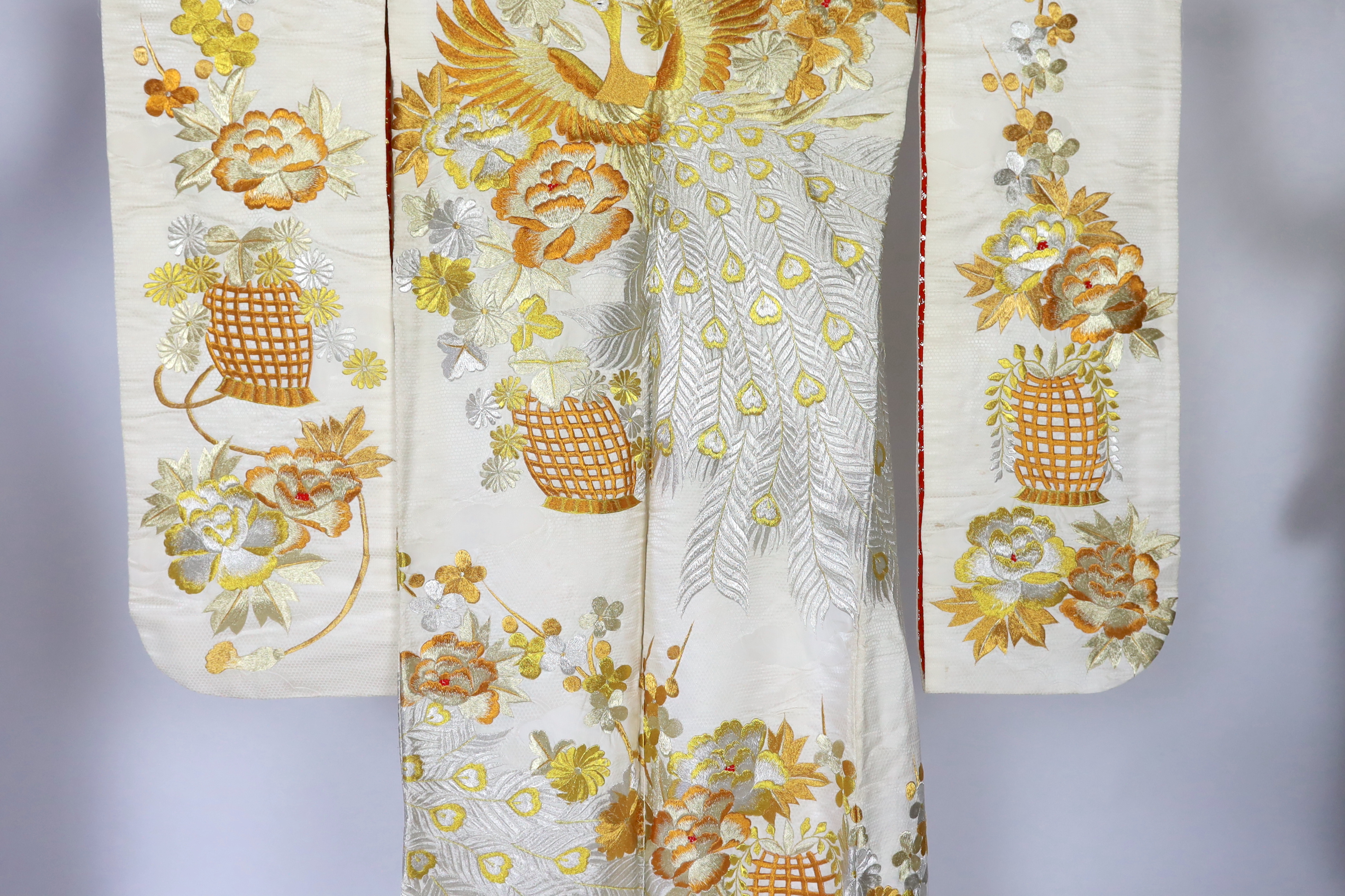 A 1960s-70s vintage Japanese embroidered wedding kimono, embroidered with pewter, bronze, silver and gold coloured metallic threads, into a large decorative design of peacocks with fanned tail feathers and trailing flowe